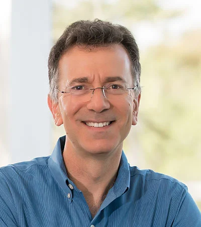 Dr. David Rosenberg in a blue shirt, photographed close in natural light.